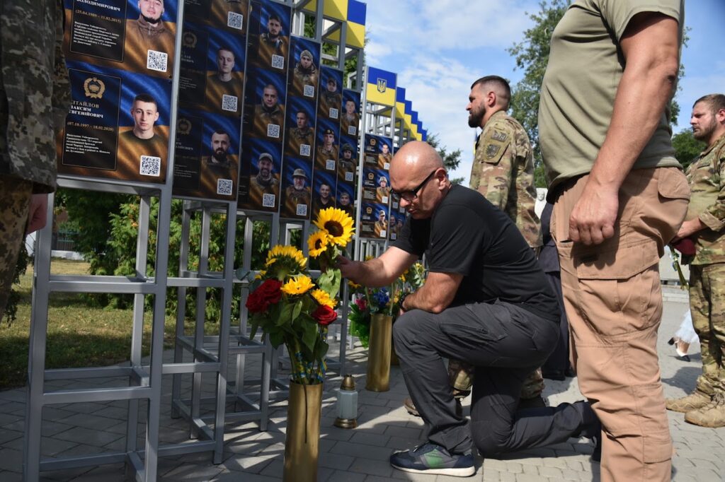 Гості заходу кладуть квіти до меморіалу