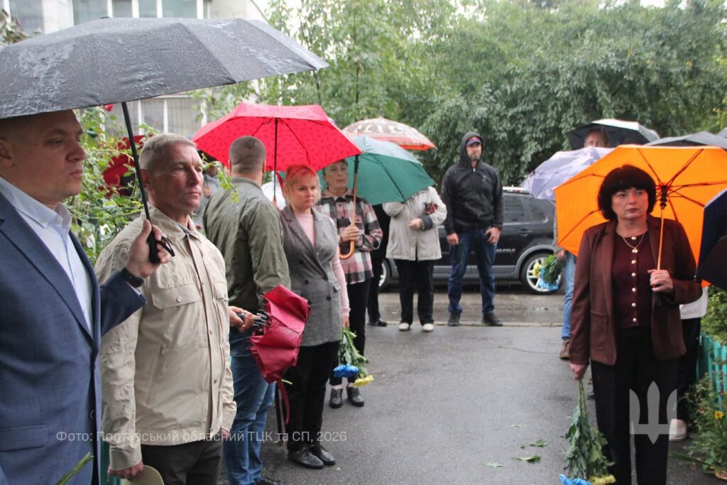 люди у дворі будинку, під парасольками