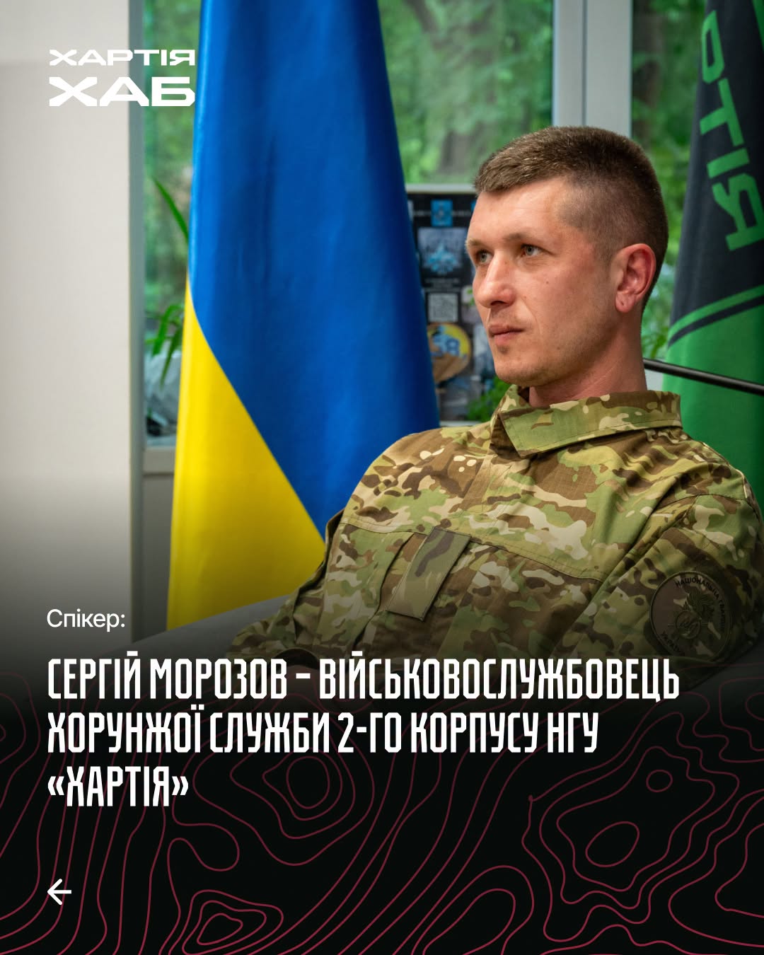 Сергій Морозов у військовій формі біля прапорів України та корпусу Хартія