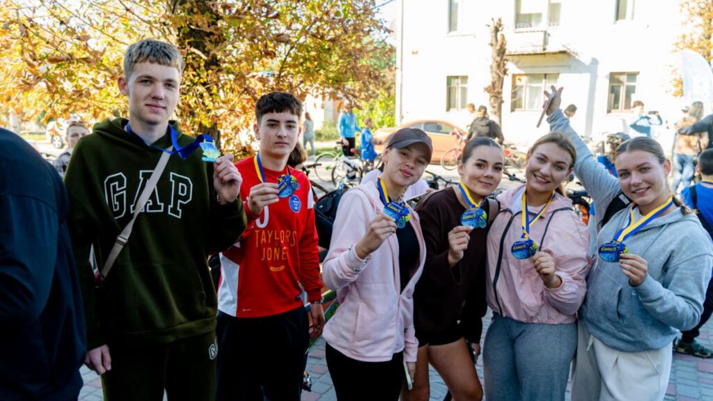 п'ятеро підлітків демонструють пам'ятні медалі